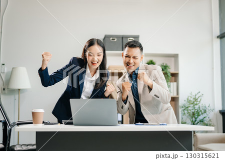 Happy businesspeople while collaborating on a new project in an office. team of diverse businesspeople using a laptop and tablet 130315621