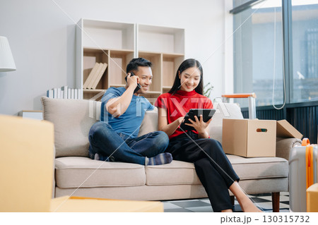 Asia young couple man and woman sit on couch use joystick controller play video game spend fun time together Asia young couple man and woman sit on couch use joystick controller play video game spend fun time together 130315732