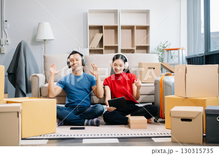 Asian young attractive couple man and woman use tablet and smartphone online shopping furniture decorate house 130315735