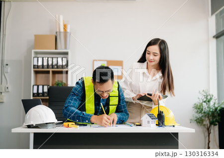 Engineer Teamwork Meeting, Drawing working on blueprint meeting for project working with partner on model building at company office 130316334