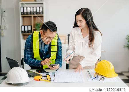 Engineer Teamwork Meeting, Drawing working on blueprint meeting for project working with partner on model building at company office 130316343