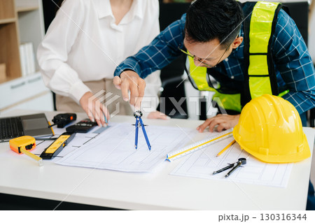 Engineer Teamwork Meeting, Drawing working on blueprint meeting for project working with partner on model building at company office 130316344