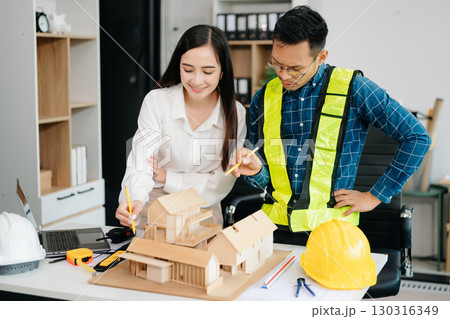 Engineer Teamwork Meeting, Drawing working on blueprint meeting for project working with partner on model building at company office 130316349