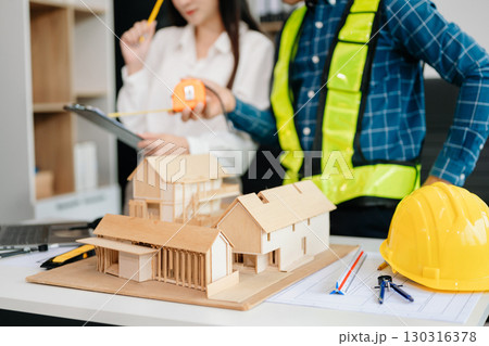Creative architect projecting on the big drawings with architectural project at construction site at desk Creative architect projecting on the big drawings with architectural project at construction site at desk 130316378