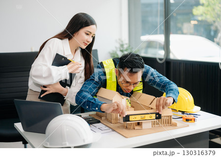 Creative architect projecting on the big drawings with architectural project at construction site at desk 130316379