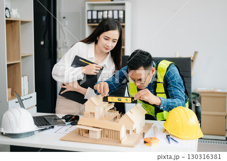 Creative architect projecting on the big drawings with architectural project at construction site at desk 130316381