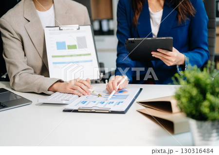 Businessman and team analyzing financial statement Finance task. with smart phone and laptop and tablet. Businessman and team analyzing financial statement Finance task. with smart phone and laptop and tablet. 130316484
