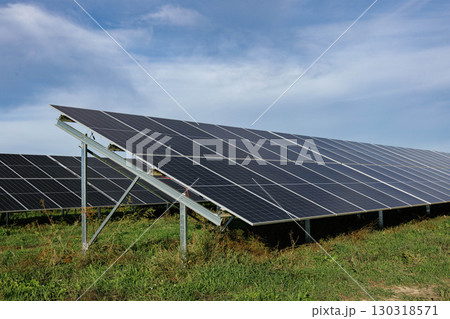 Solar panels providing clean energy under a cloudy sky 130318571