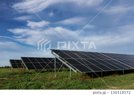 Solar panels providing clean energy under a cloudy sky Solar panels providing clean energy under a cloudy sky 130318572
