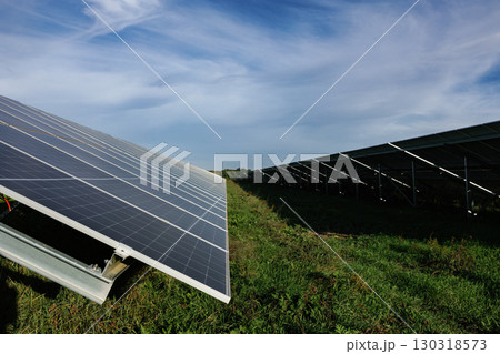 Solar panels providing clean energy under a cloudy sky 130318573