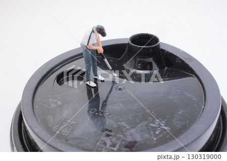 Miniature Figure Performing Maintenance on a Plastic Cup Lid Surface Miniature Figure Performing Maintenance on a Plastic Cup Lid Surface 130319000