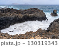 Waves crashing against rugged black volcanic rocks along the coast of La Graciosa, Lanzarote, with a view of the sea. 130319343