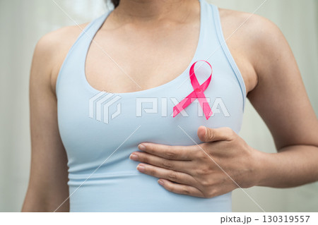 Breast cancer, pink ribbon at Asian senior lady for supporting awareness, symbol of World Breast Cancer Day. Breast cancer, pink ribbon at Asian senior lady for supporting awareness, symbol of World Breast Cancer Day. 130319557