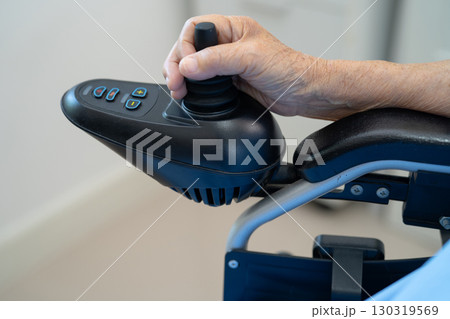 Asian senior woman patient on electric wheelchair with remote control at hospital, healthy strong medical. Asian senior woman patient on electric wheelchair with remote control at hospital, healthy strong medical. 130319569