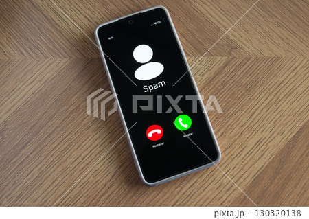 Incoming spam call on mobile phone on table Incoming spam call on mobile phone on table 130320138
