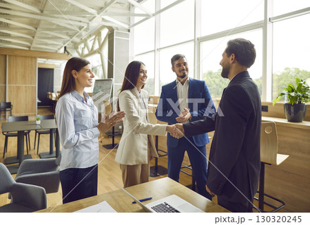 Business people meet in office, negotiate deals, make agreements and exchange handshakes 130320245