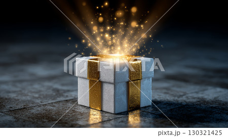 Magical glowing light sparkles from white gift box with golden ribbon on dark textured floor, creating festive and enchanting atmosphere 130321425