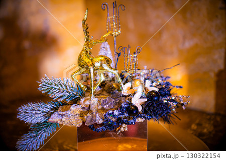 Christmas table composition. Beautiful decoration. Christmas trees, candles, stars, lights and elegant accessories. Merry Christmas and Happy Holidays, Template. 130322154