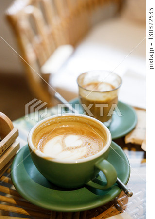 Cup of hot milk latte coffee and piccolo latte coffee on table by the window. Cup of hot milk latte coffee and piccolo latte coffee on table by the window. 130322535