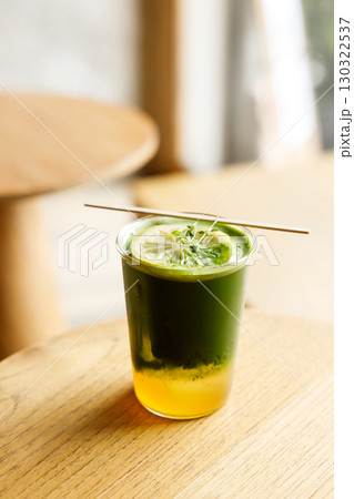 Creation beverage of fresh matcha tea, green tea and lemon juice on wooden table by the window. Creation beverage of fresh matcha tea, green tea and lemon juice on wooden table by the window. 130322537