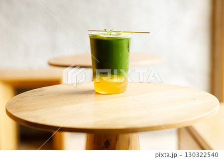 Creation beverage of fresh matcha tea, green tea and lemon juice on wooden table by the window. Creation beverage of fresh matcha tea, green tea and lemon juice on wooden table by the window. 130322540