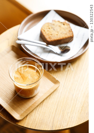 Cup of milk dirty coffee on table by the window. Cup of milk dirty coffee on table by the window. 130322543