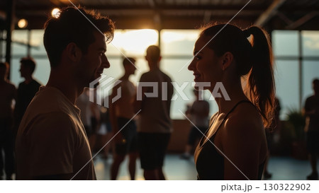 Young couple gracefully dancing Kizomba together in a beautiful dance studio at sunset 130322902