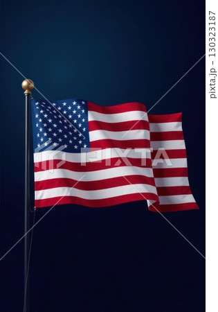 American flag waving on flagpole against dark blue background 130323187