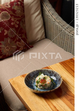 Exquisite gourmet dish artfully presented on an elegant and beautifully arranged table Exquisite gourmet dish artfully presented on an elegant and beautifully arranged table 130323213