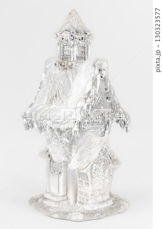 Glass christmas figurine of a house with snow. christmas Composition on gray background. Home sweet home christmas concept Glass christmas figurine of a house with snow. christmas Composition on gray background. Home sweet home christmas concept 130323577