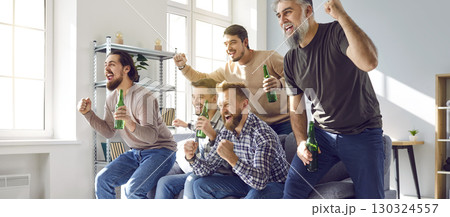 Male football fans watching soccer on tv at home 130324557