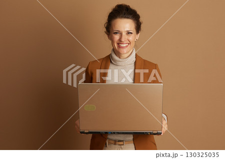 Smiling Professional with Bronze Laptop Smiling Professional with Bronze Laptop 130325035