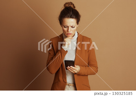 Thoughtful Businesswoman with Smartphone Concern 130325185