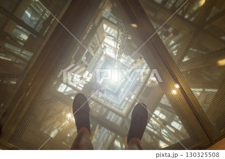 image of an elevator shaft seen from above on safety glass image of an elevator shaft seen from above on safety glass 130325508