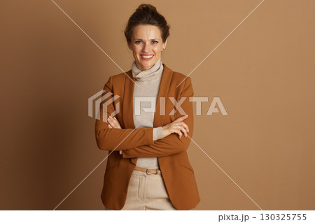 Confident Businesswoman Smiling with Crossed Arms 130325755