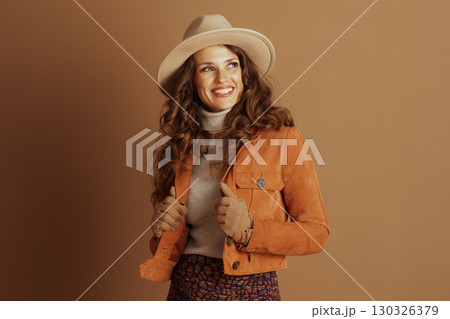 Stylish Woman Posing in Fall Suede Jacket and Fedora 130326379