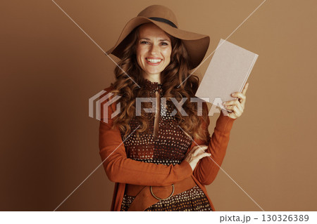 Smiling Woman with Book in Autumn Style Smiling Woman with Book in Autumn Style 130326389