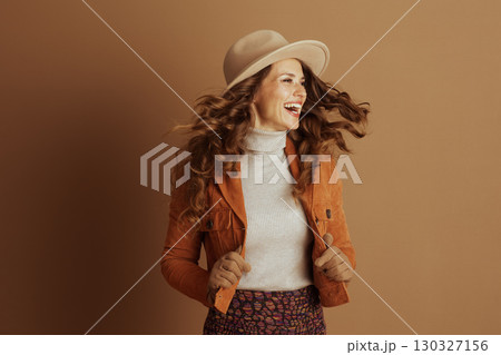 Elegant Woman in Tan Fedora and Suede Jacket Elegant Woman in Tan Fedora and Suede Jacket 130327156