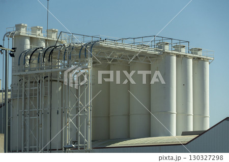 A large white building with a lot of tanks on it 130327298