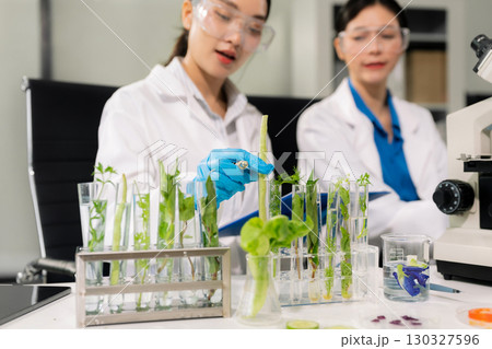 Team microbiologists and nutrition experts analyze molecular samples in advanced food science labs. 130327596