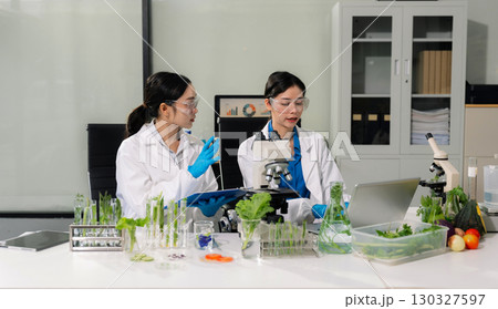 Team microbiologists and nutrition experts analyze molecular samples in advanced food science labs. Team microbiologists and nutrition experts analyze molecular samples in advanced food science labs. 130327597