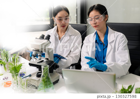 Team microbiologists and nutrition experts analyze molecular samples in advanced food science labs. Team microbiologists and nutrition experts analyze molecular samples in advanced food science labs. 130327598