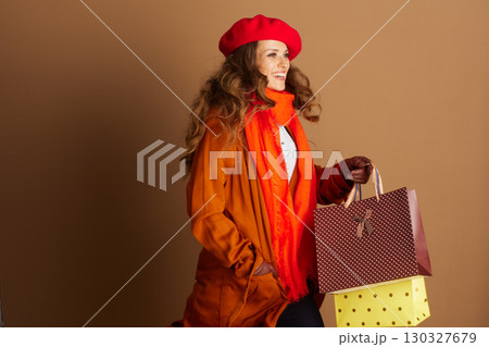 Stylish Woman Walking with Autumn Shopping Bags 130327679
