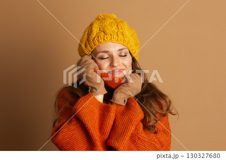 Content Woman Embracing Cozy Autumn Knitwear 130327680