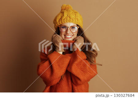 Cheerful Woman in Cozy Orange Turtleneck 130327684