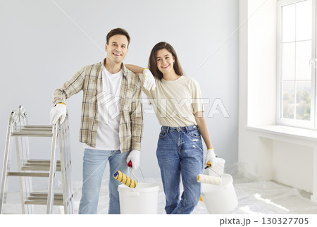 Happy Couple Painting Walls Together During Home Renovation Happy Couple Painting Walls Together During Home Renovation 130327705