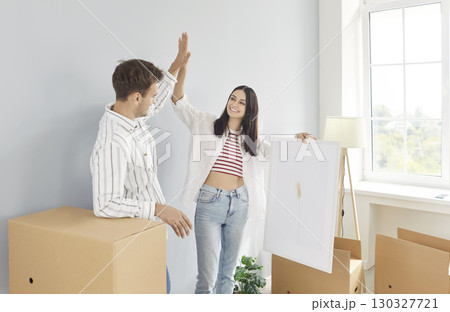 Married Couple Giving High Five During Relocation 130327721