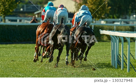 Horse racing outdoor derby with jockeys heading to finish line. Outdoor sport and competition. Horse racing outdoor derby with jockeys heading to finish line. Outdoor sport and competition. 130327948