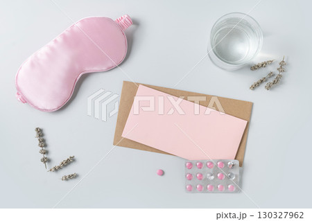 Pink sleeping mask, watch and vitamins capsules. Concept of daily routine. 130327962