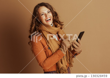 Happy Woman Pointing and Laughing at Her Smartphone Happy Woman Pointing and Laughing at Her Smartphone 130328459